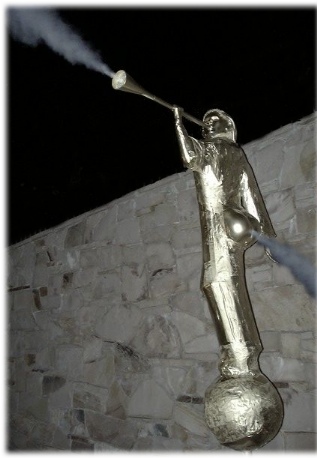 Angel Moroni blowing smoke out his ass and horn.